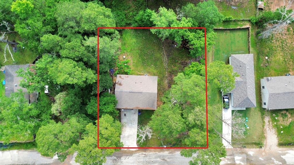 an aerial view of a house a yard and outdoor seating