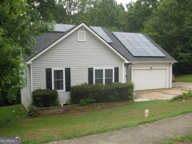 a front view of a house with garden