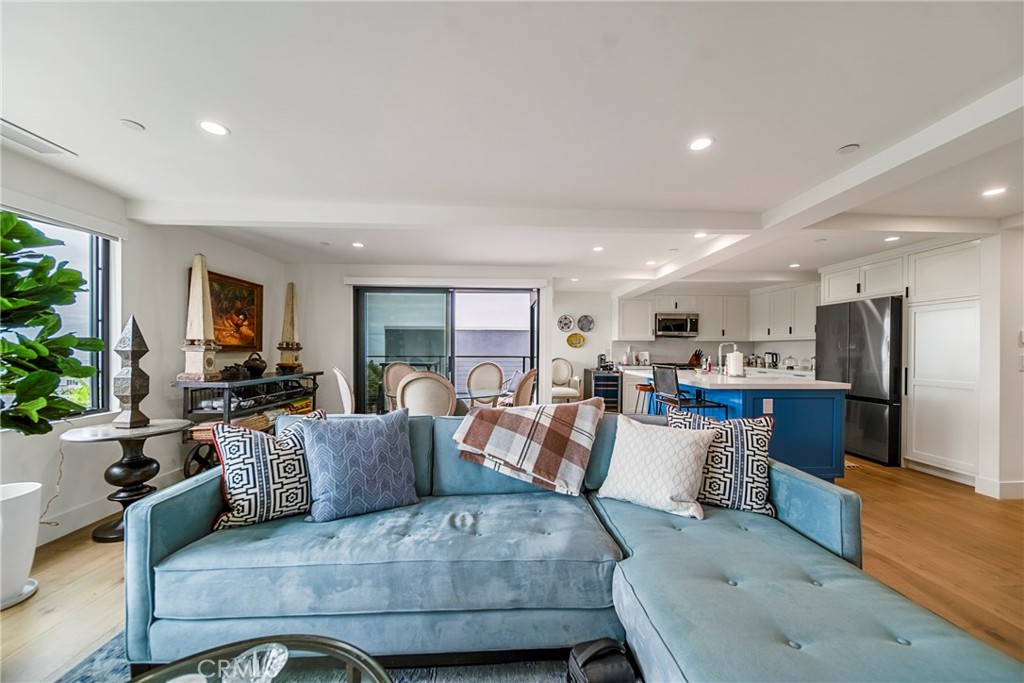 a living room with furniture kitchen and a table