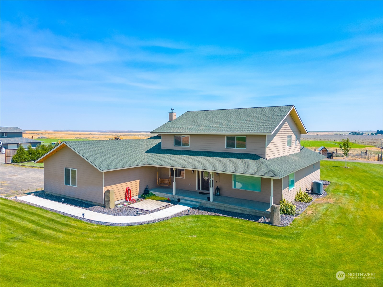 a aerial view of a house with swimming pool and a yard