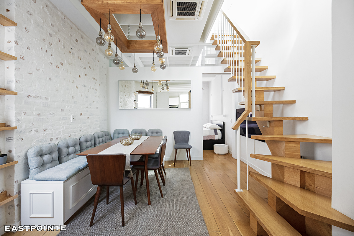 a dining room with furniture and wooden floor