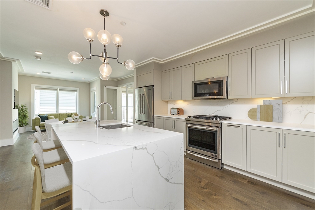 a kitchen with sink a stove and microwave