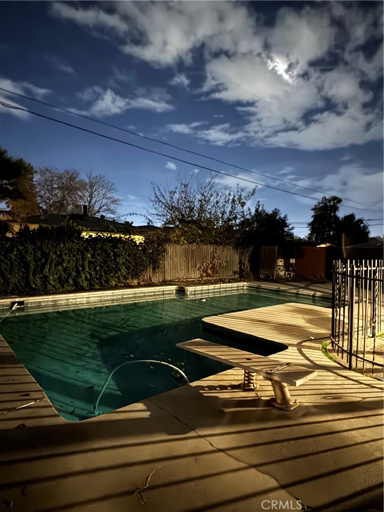 a view of a swimming pool with an outdoor seating a yard and ocean view