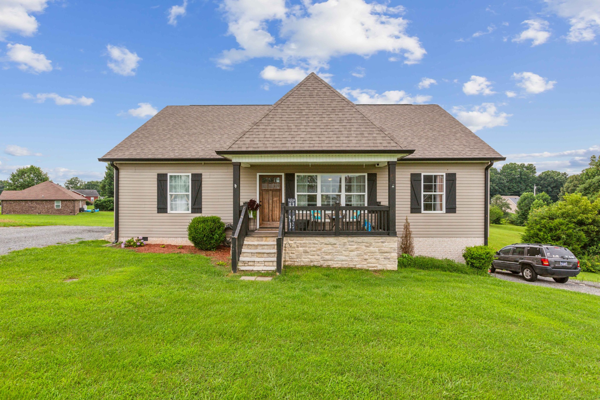 a front view of house with yard and green space