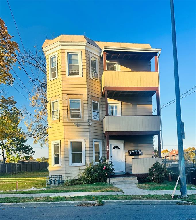 View of front of property featuring a balcony