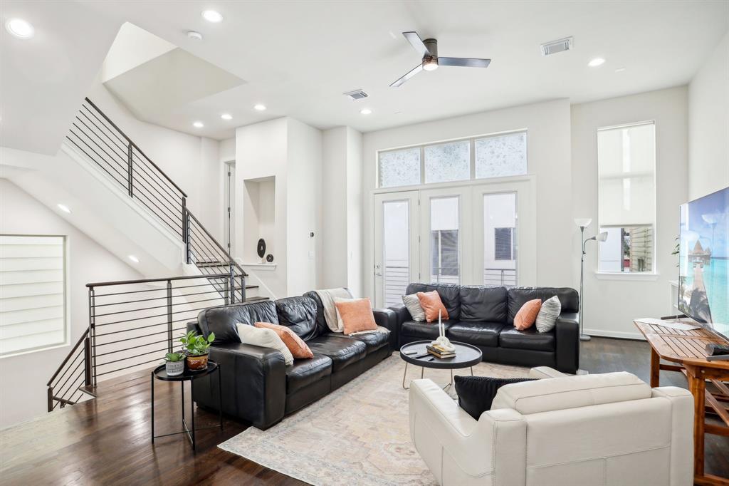 a living room with furniture and wooden floor