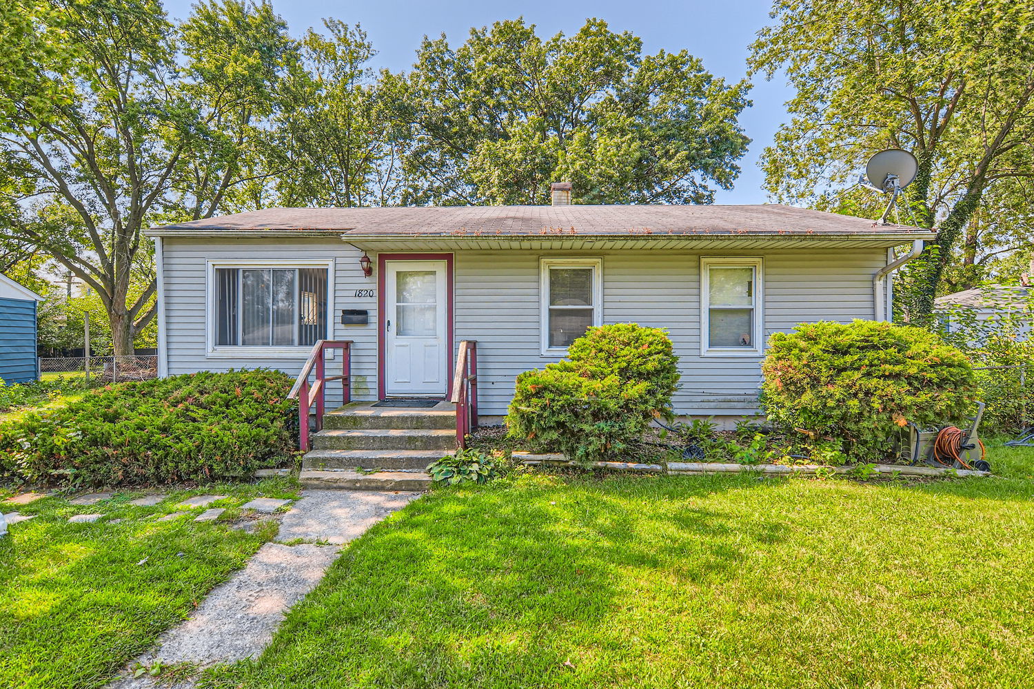 a front view of house with yard and green space