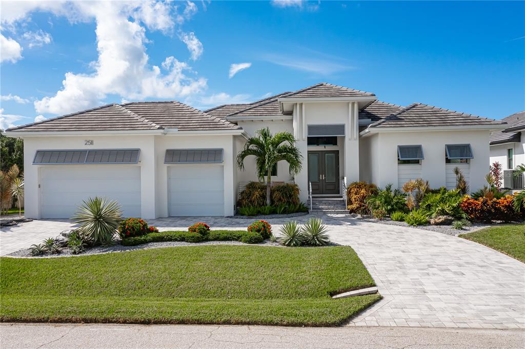 a front view of a house with a garden