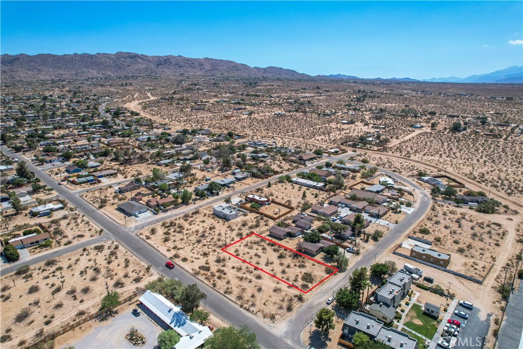 an aerial view of residential building and mountain view in back