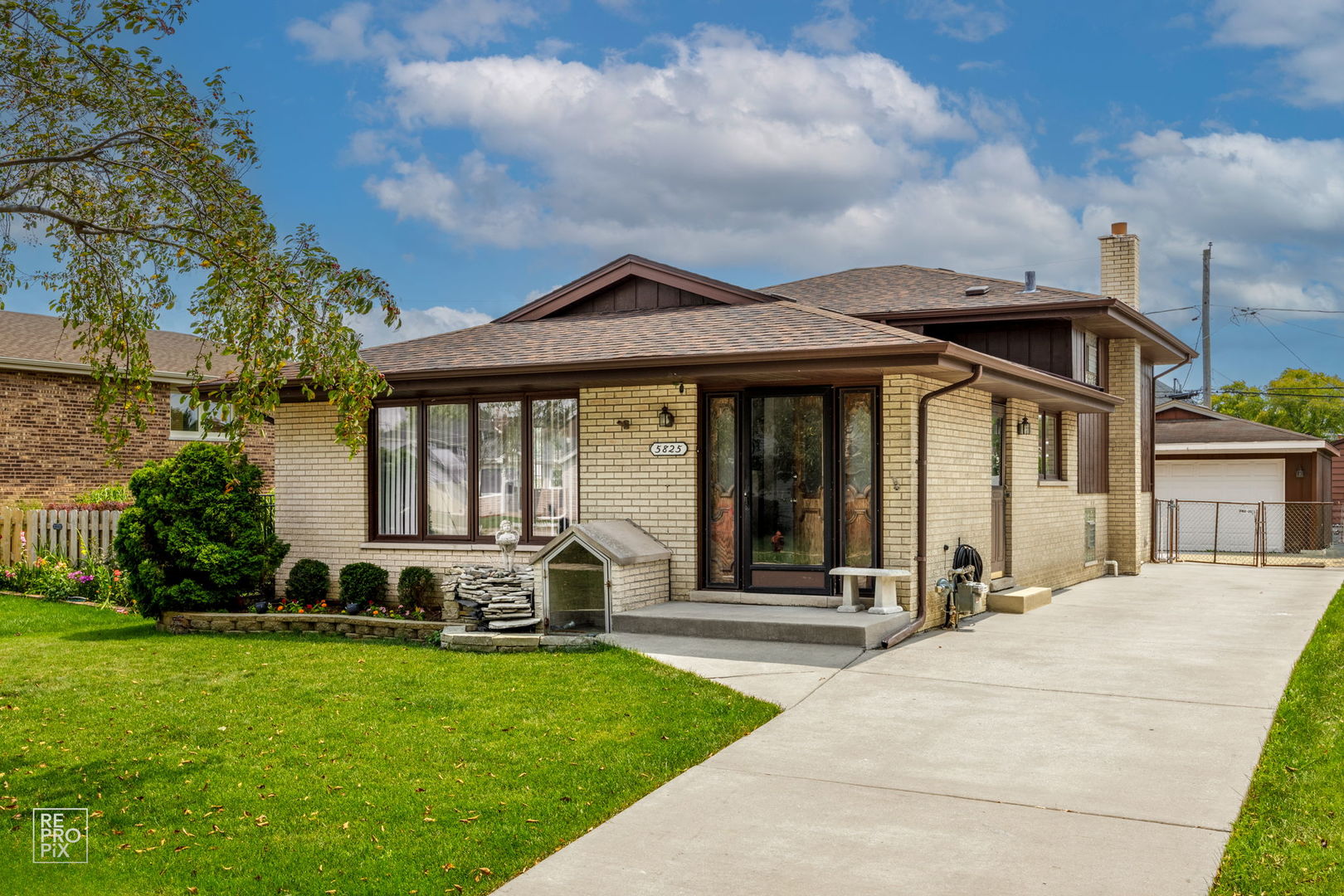 a front view of a house with garden