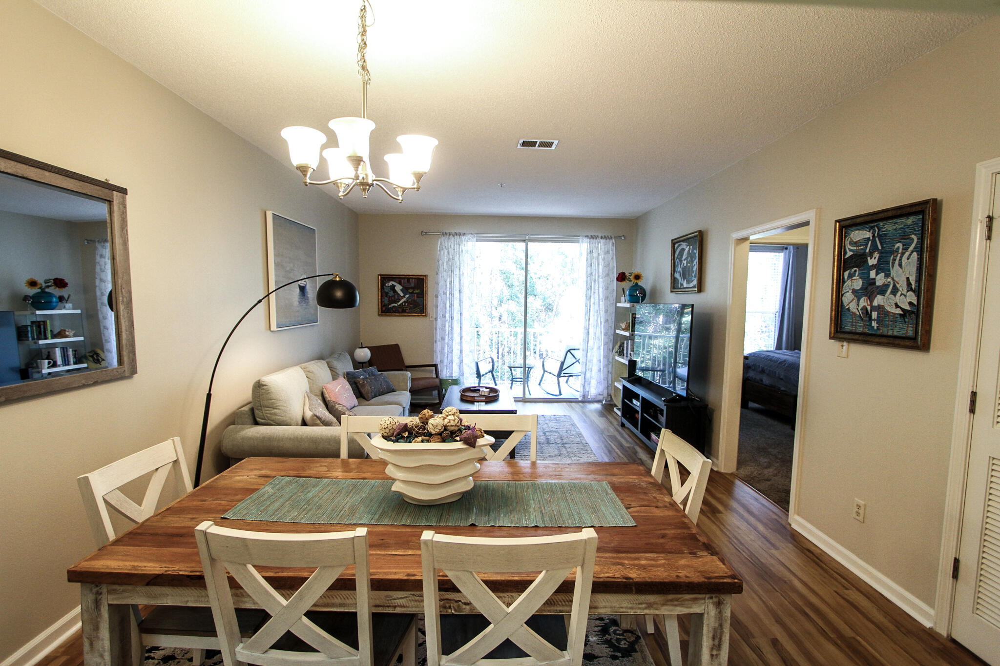 a living room with furniture dining table and a large window