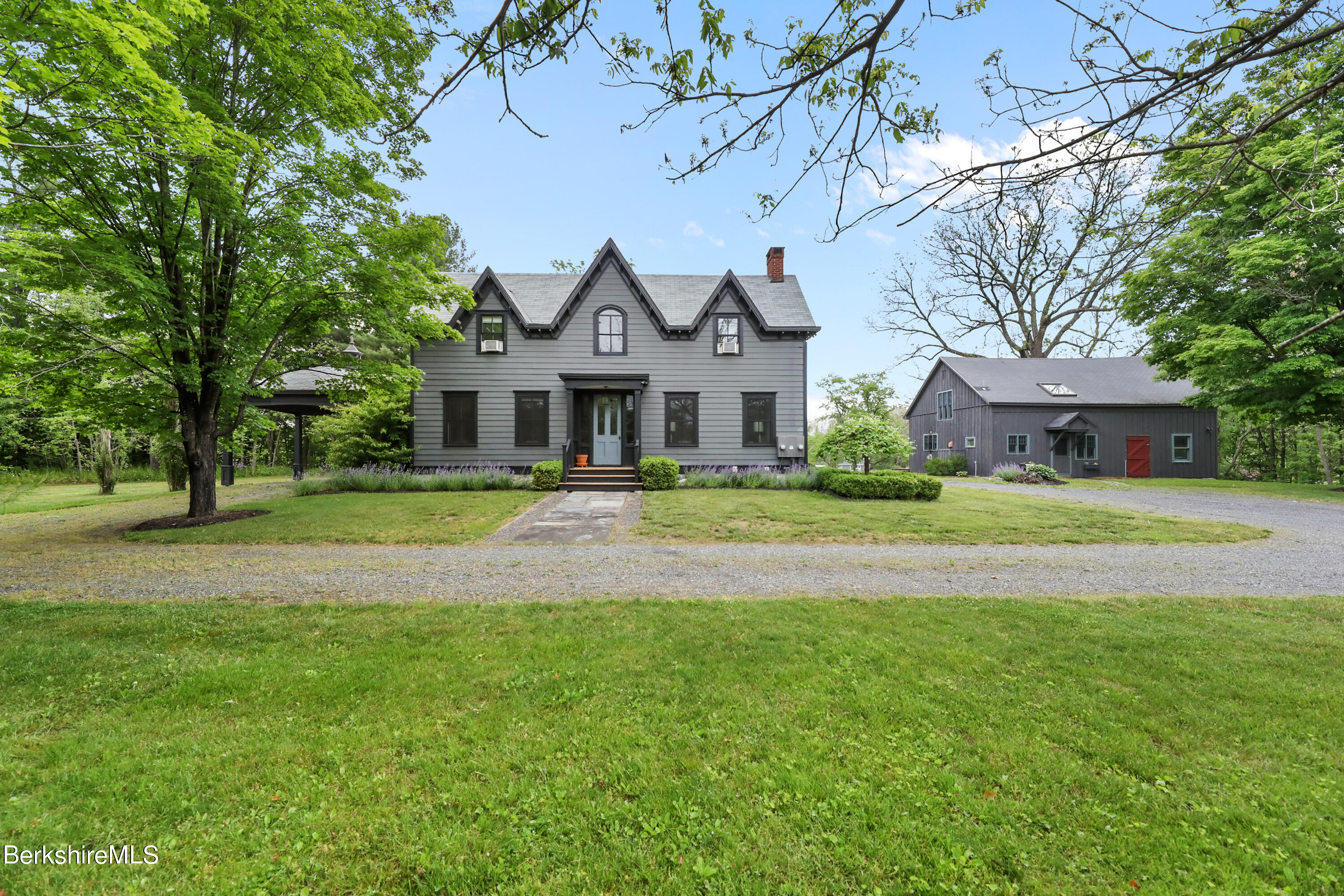 a front view of a house with yard and green space