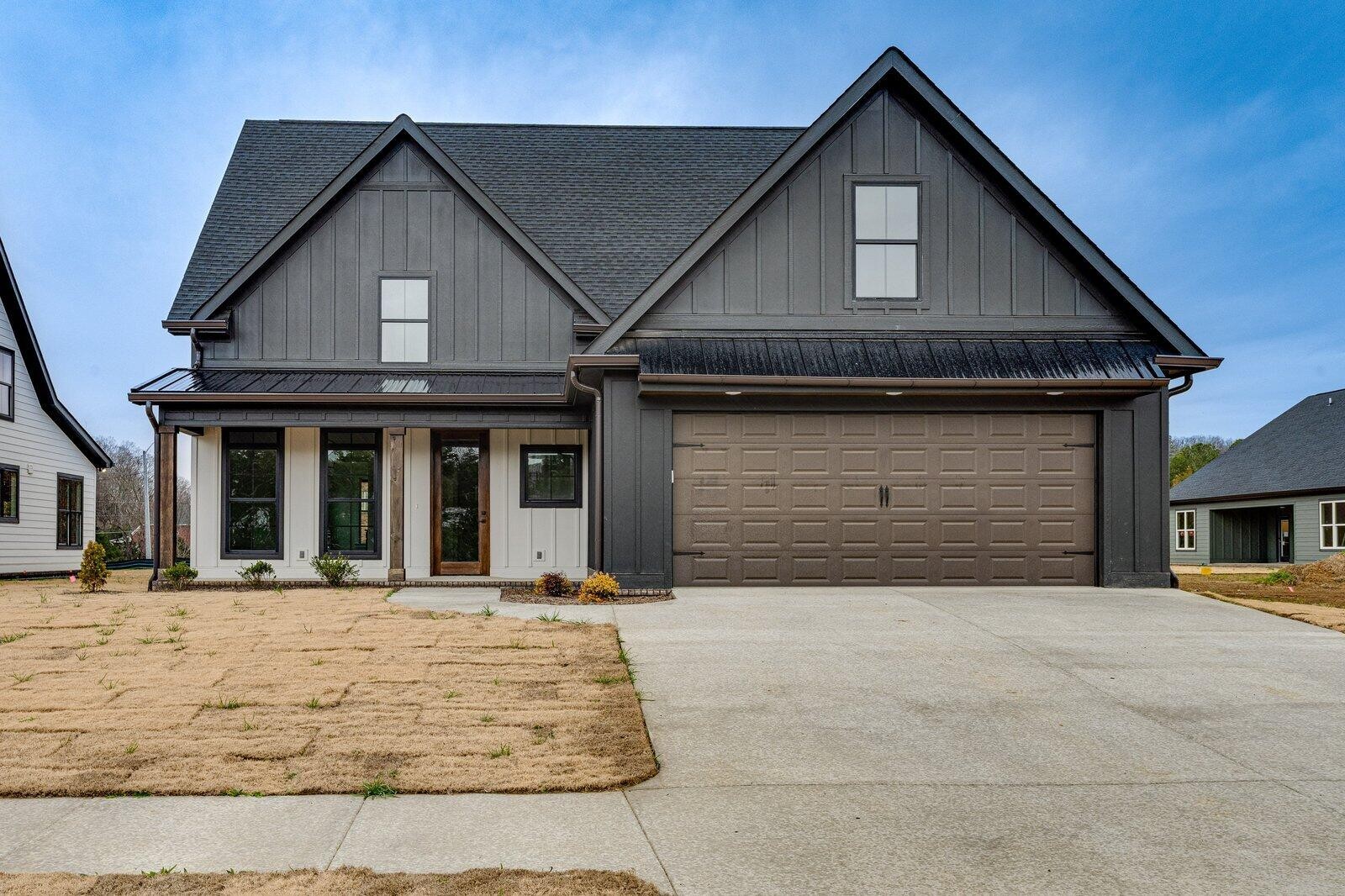 a front view of a house with a yard and garage