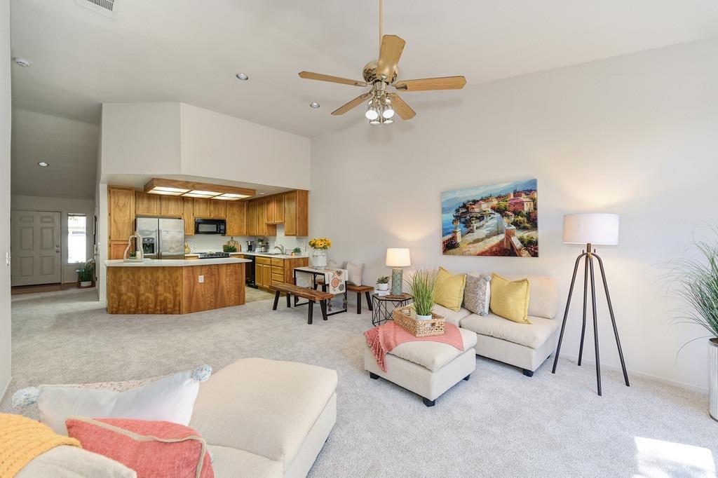 a living room with furniture and kitchen view