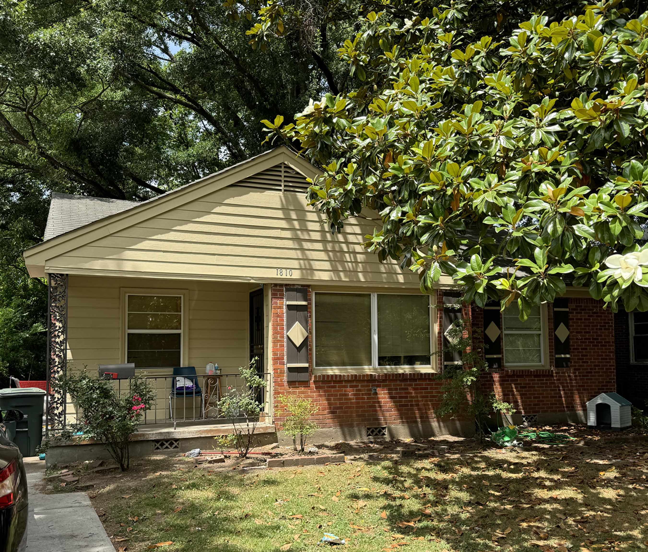 a view of a house with backyard porch and sitting area