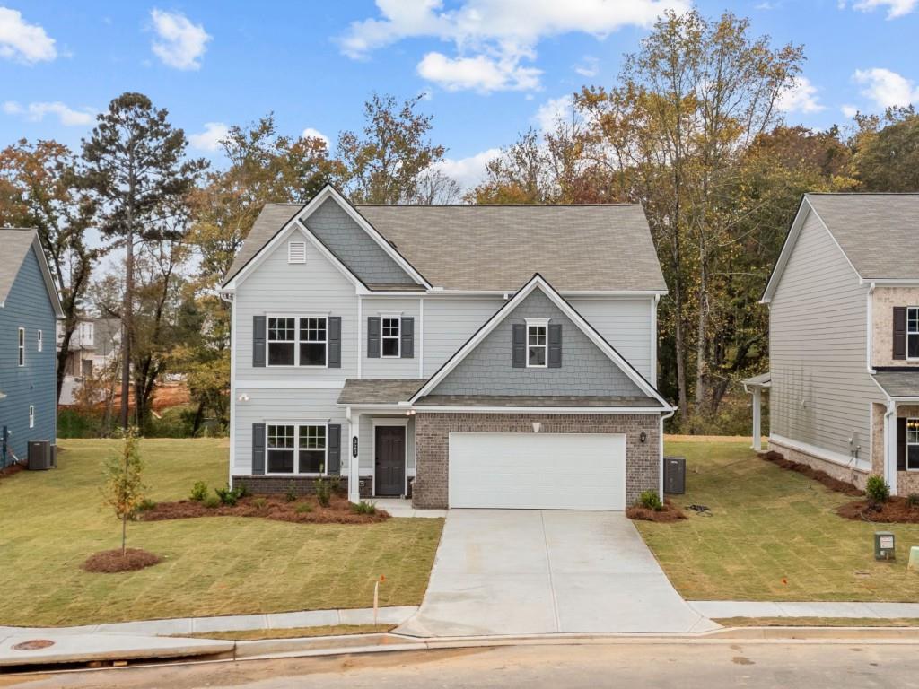 a front view of a house with a yard garage and outdoor seating