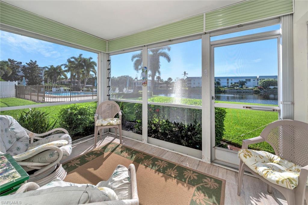 a living room filled with furniture and a large window