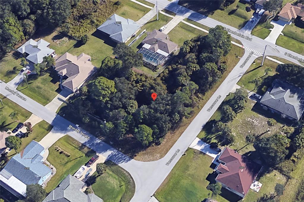 an aerial view of a house with a yard