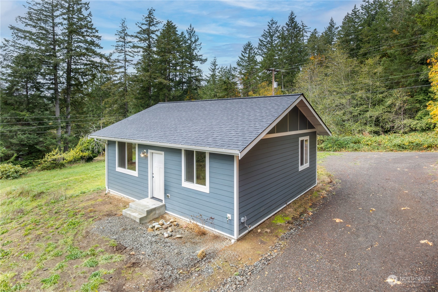 a aerial view of a house next to a yard