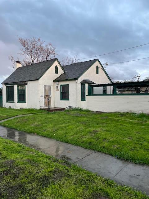 a front view of a house with a garden and yard