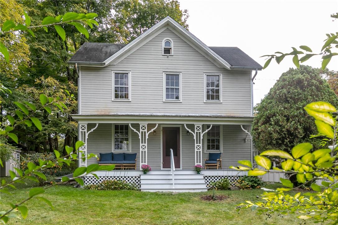 a front view of a house with a garden and plants