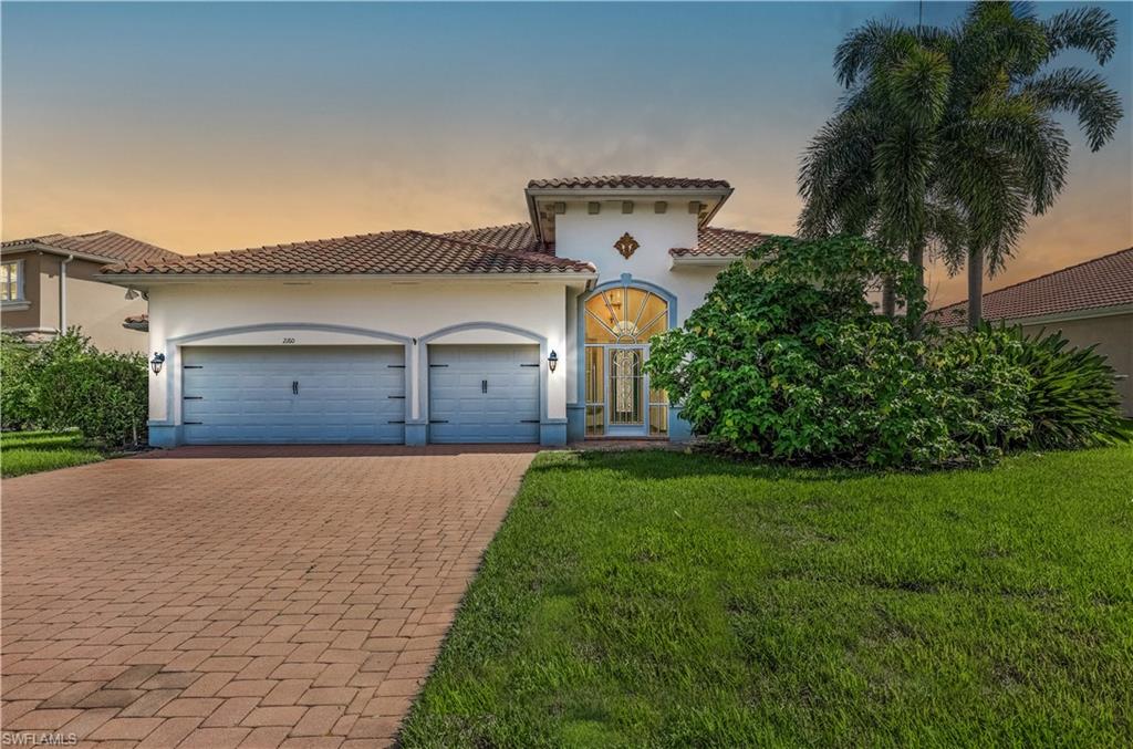 a front view of a house with a yard and garage