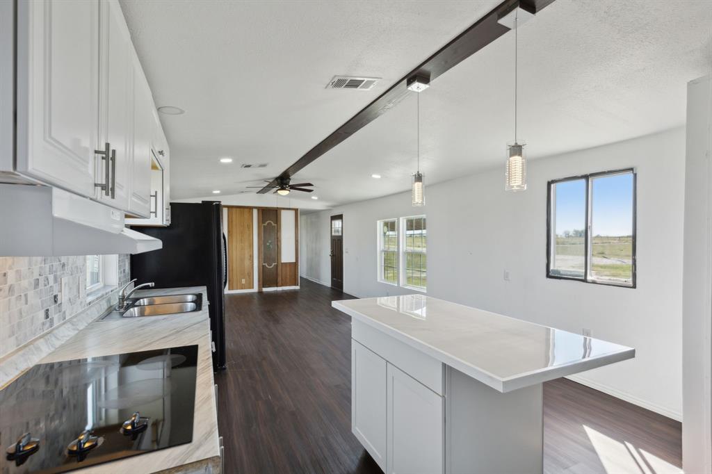 a view of kitchen with cabinets and wooden floor