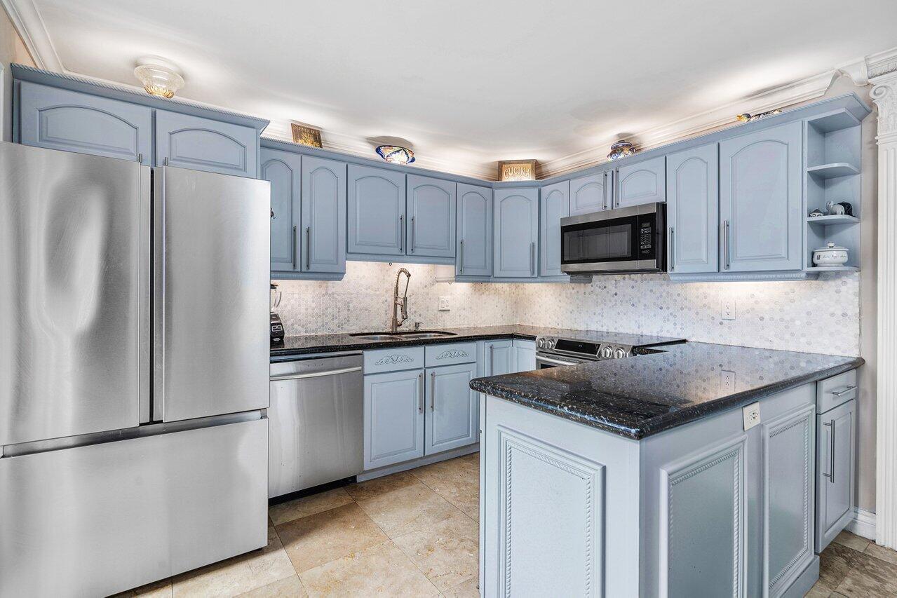 a kitchen with a refrigerator sink and microwave