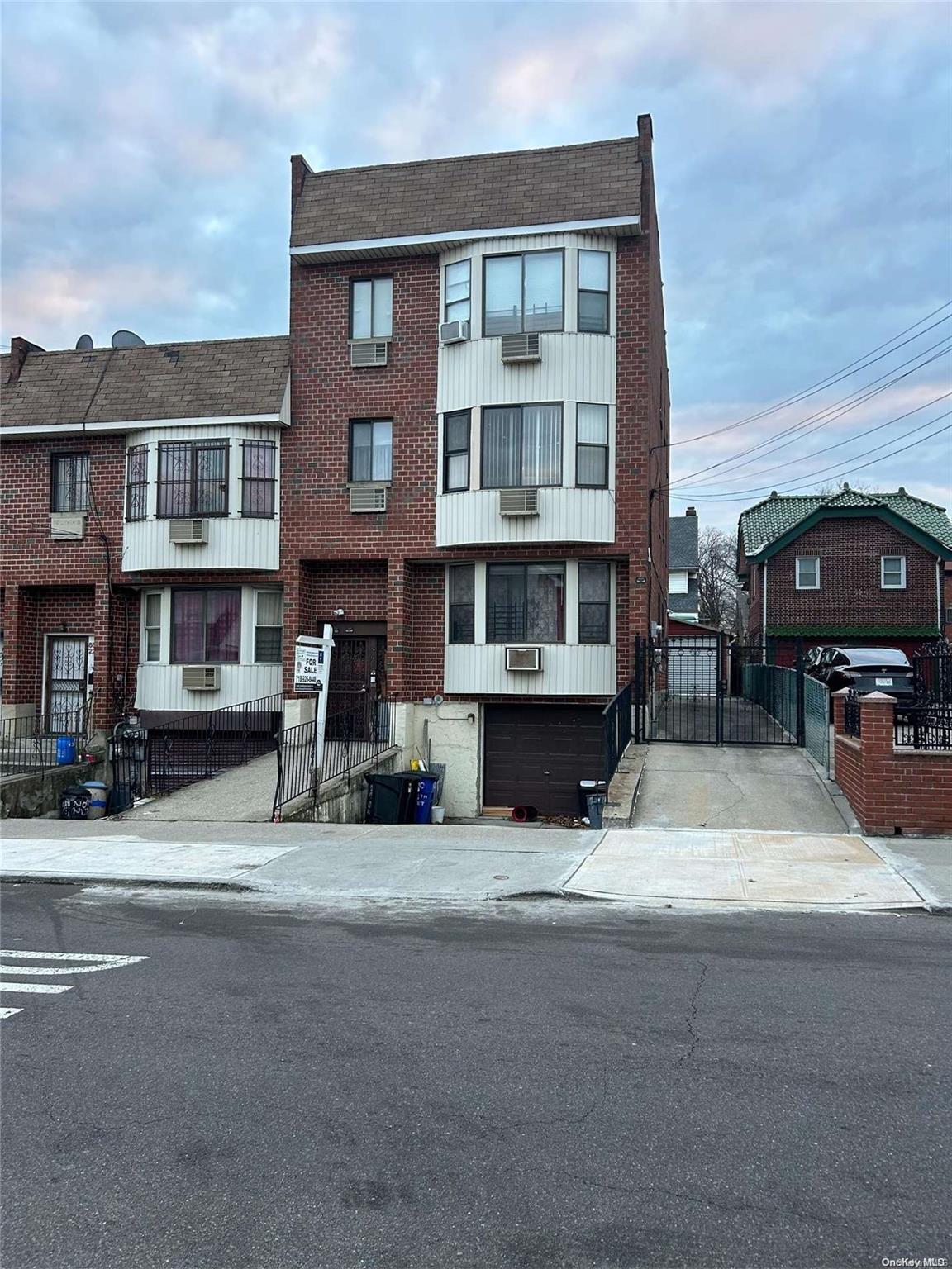 a view of a street that has couple of cars parked on the road