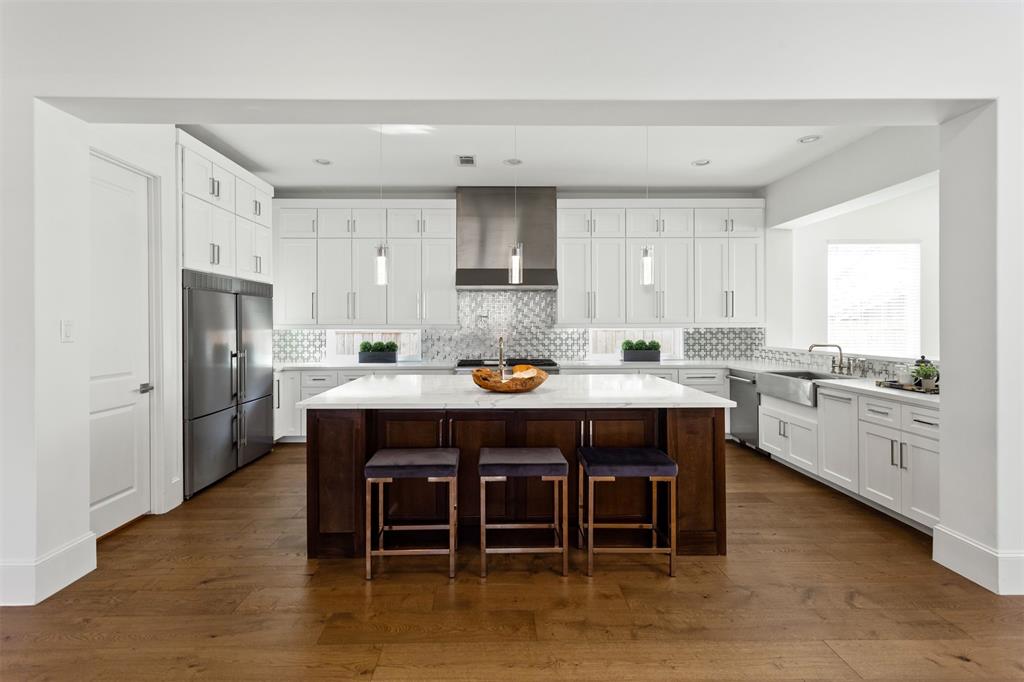 a kitchen with a sink appliances and cabinets