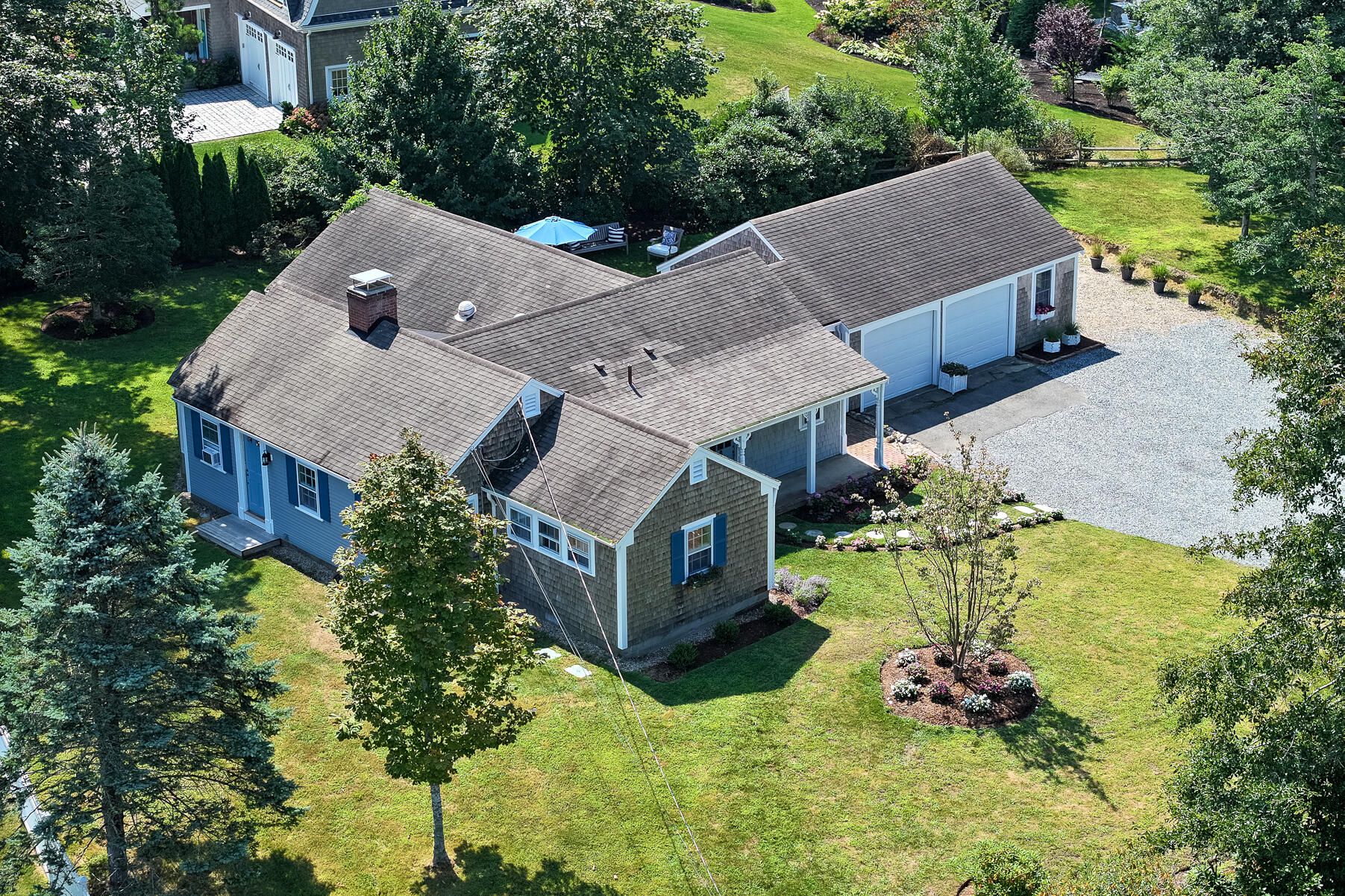 an aerial view of a house with a yard basket ball court and outdoor seating