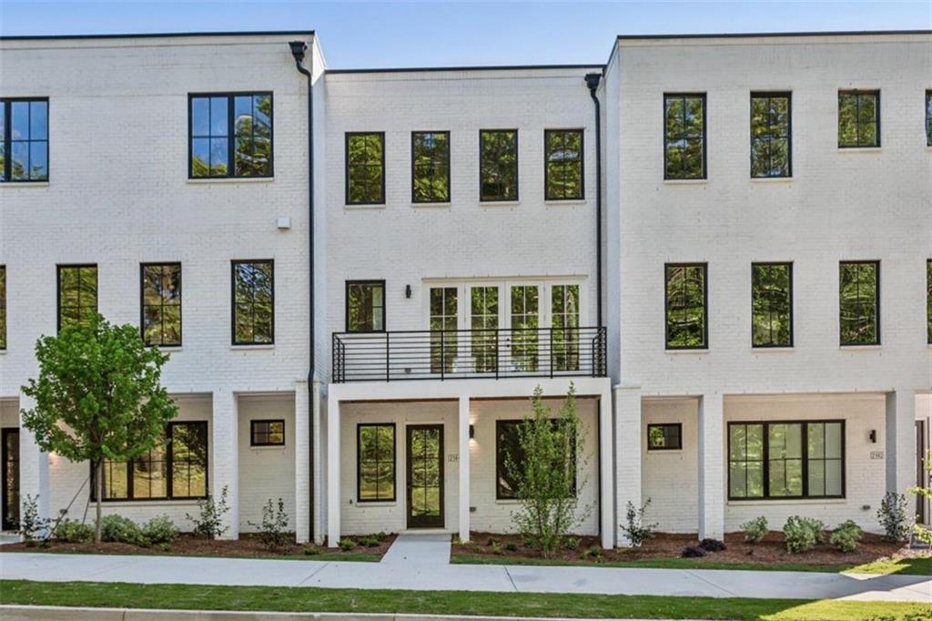 a front view of a residential apartment building with a yard