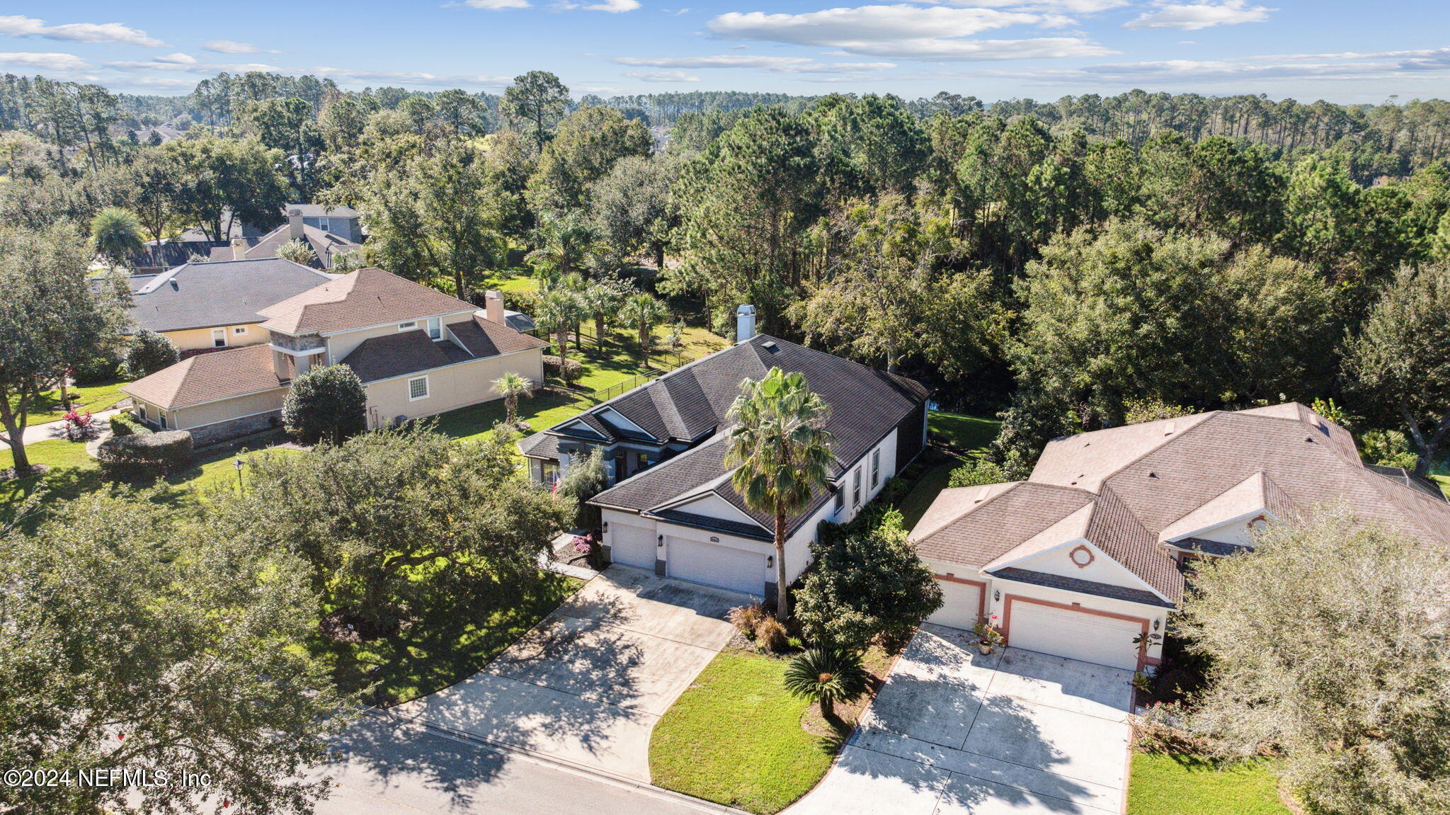 an aerial view of a house with yard swimming pool and outdoor seating