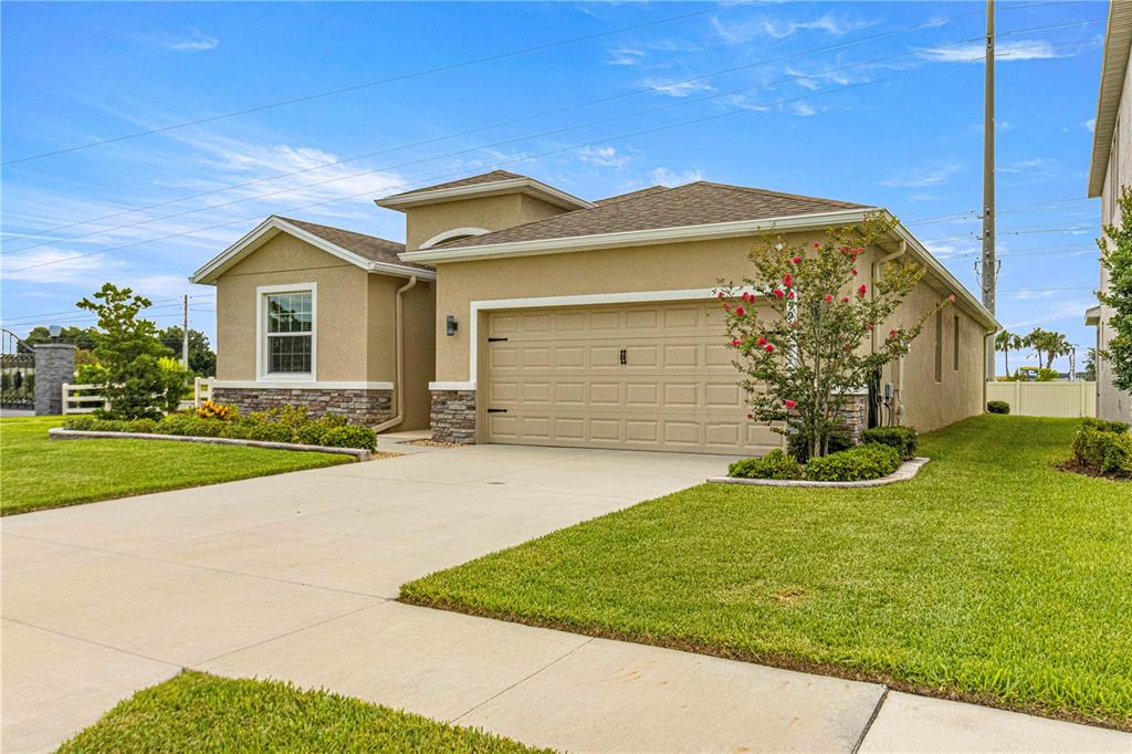 a front view of a house with a yard and garage