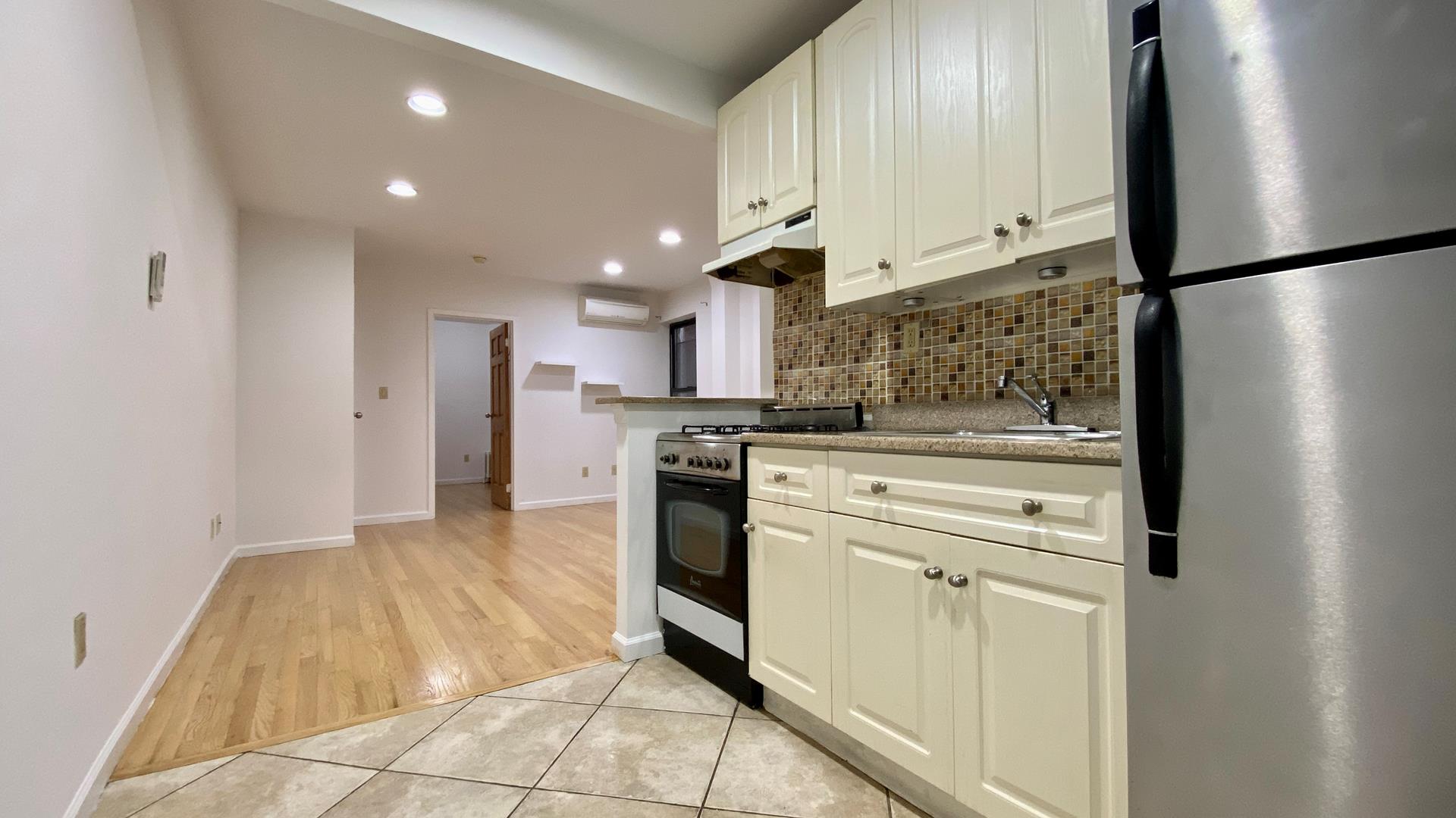 a kitchen with stainless steel appliances a refrigerator sink and cabinets