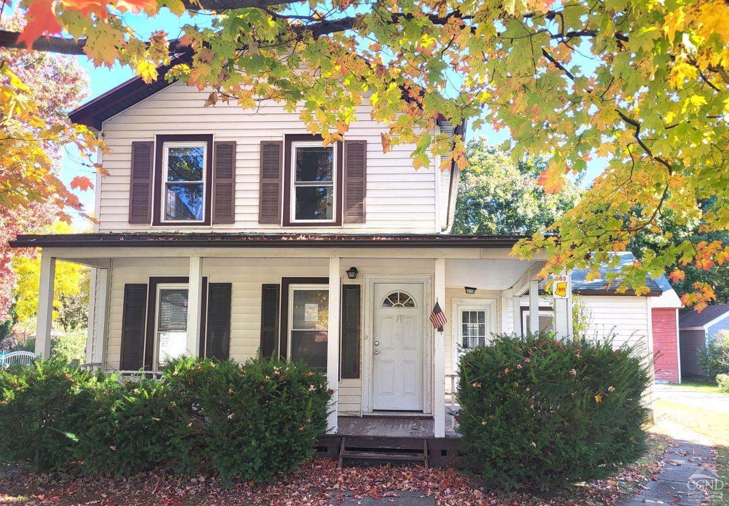 front view of a house with a tree