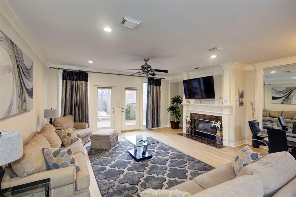 a living room with furniture flat screen tv and a fireplace