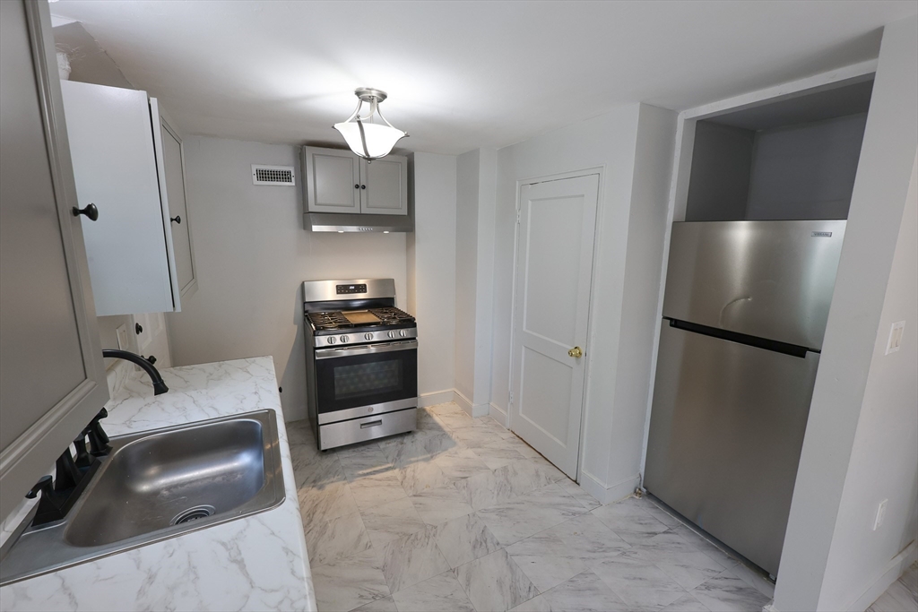 a kitchen with a refrigerator and a sink