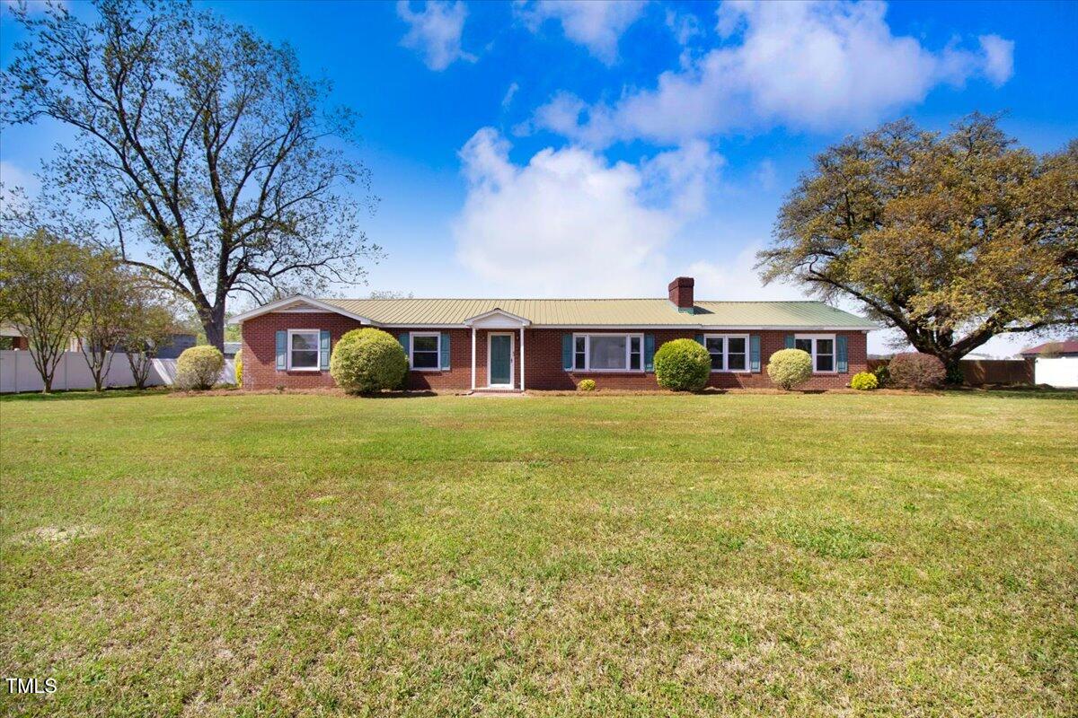 a front view of house with yard and green space