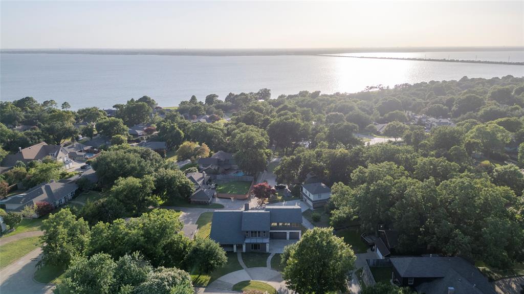 an aerial view of a house with a yard and lake view