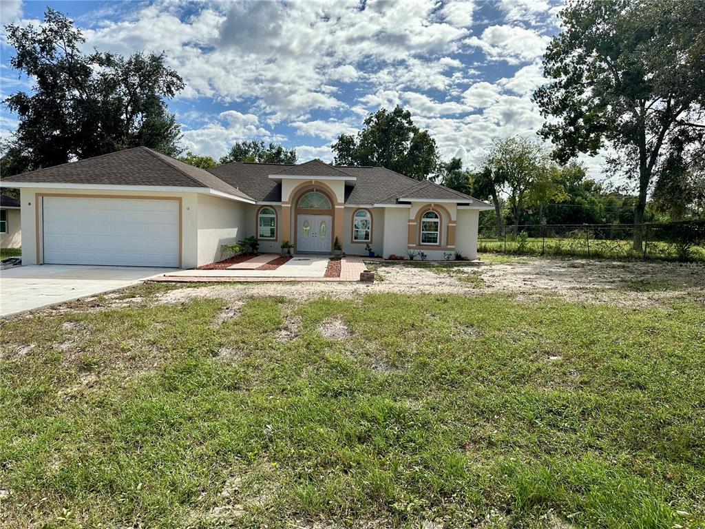 front view of a house with a yard