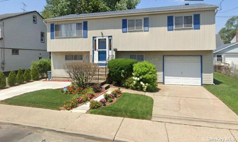 a front view of a house with a yard and potted plants