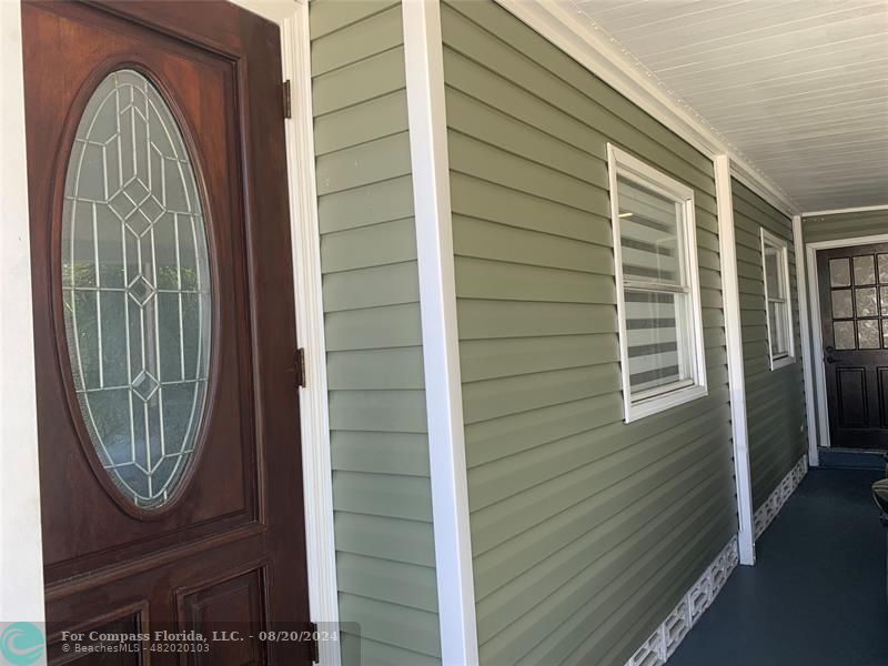 a view of a door of a house with wooden door