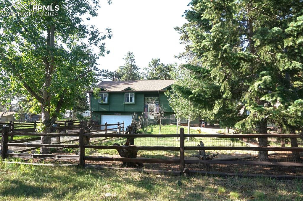 a view of house with a yard