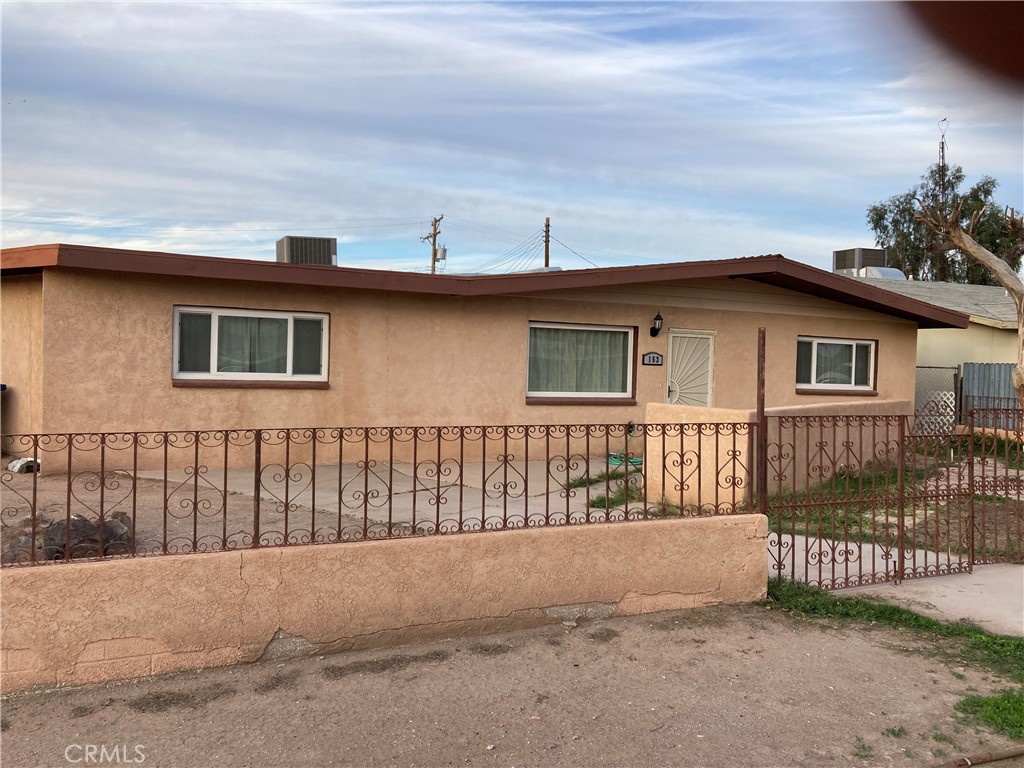 a view of a house with wooden fence