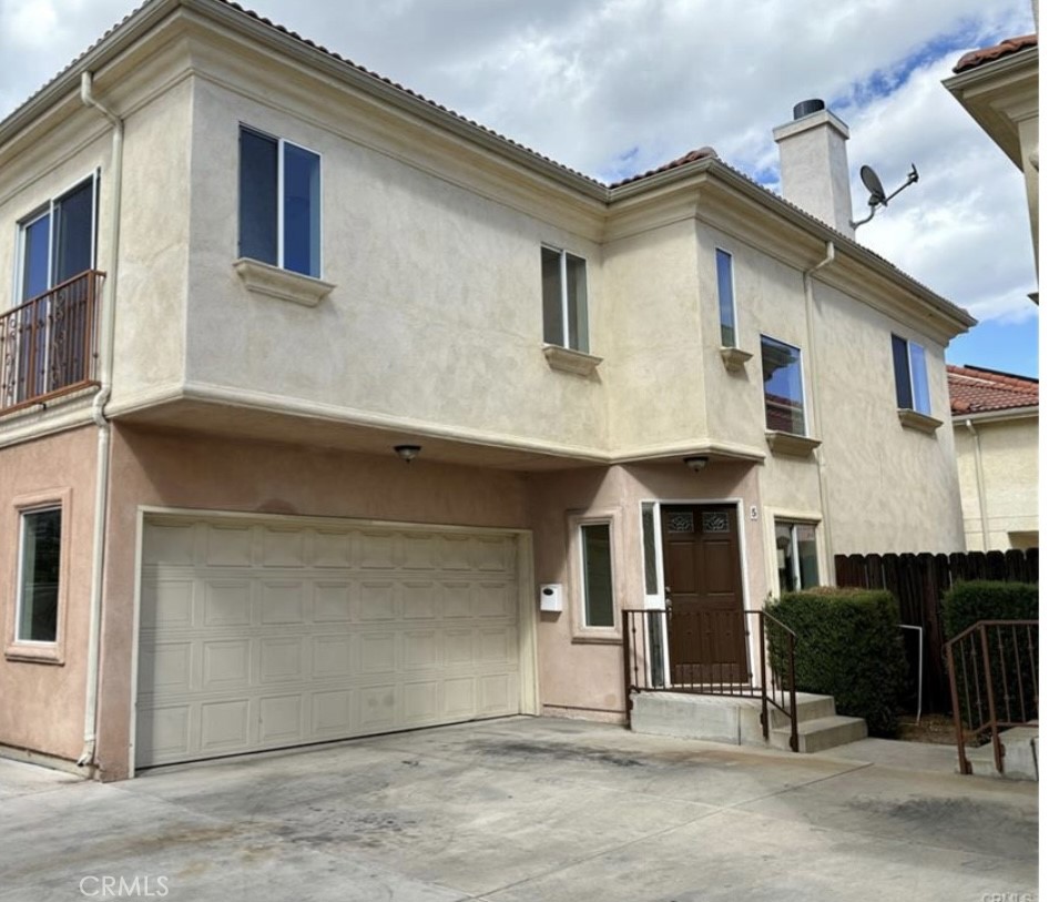 a front view of a house with a garage