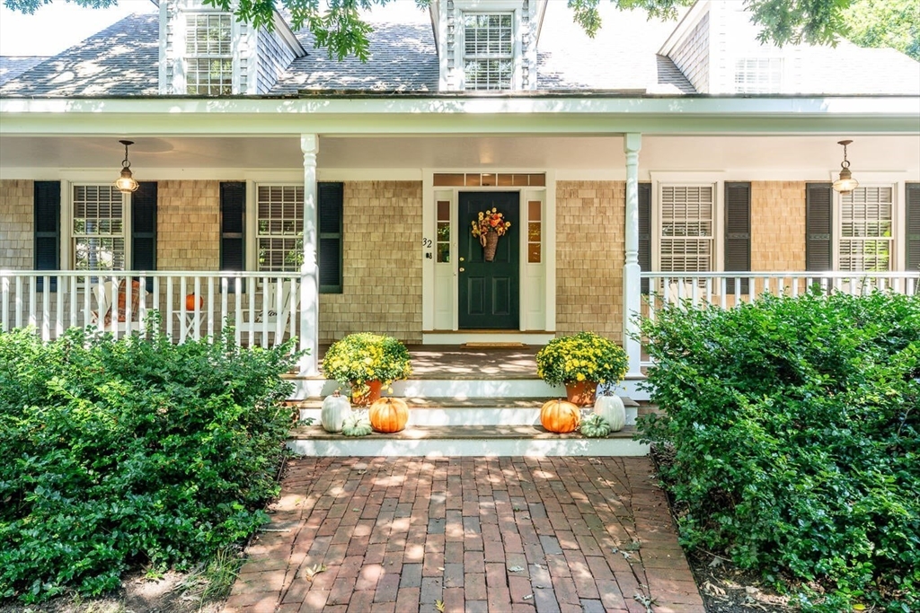 a front view of a house with outdoor seating