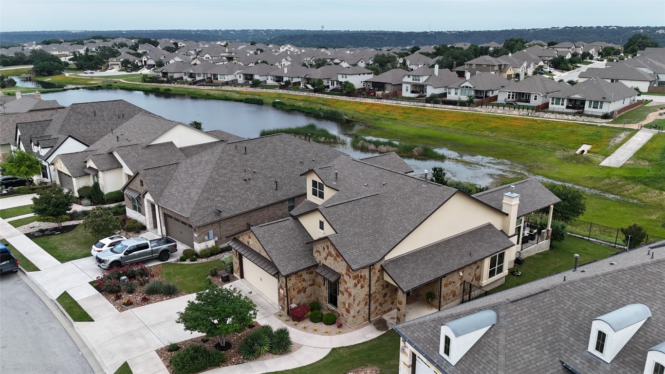 an aerial view of a house with a garden and lake view