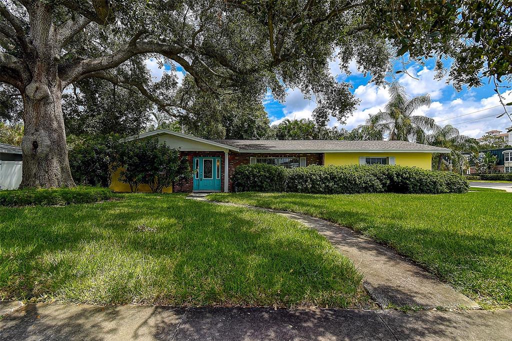 a view of house with a backyard