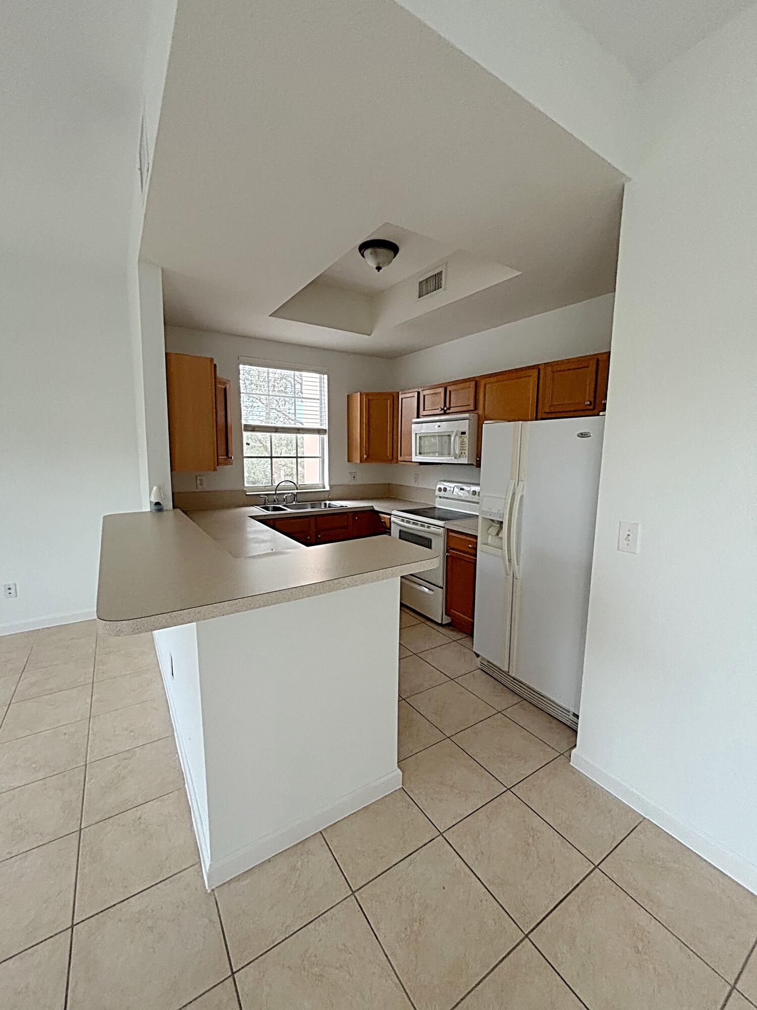 a kitchen with stainless steel appliances granite countertop a refrigerator sink and cabinets